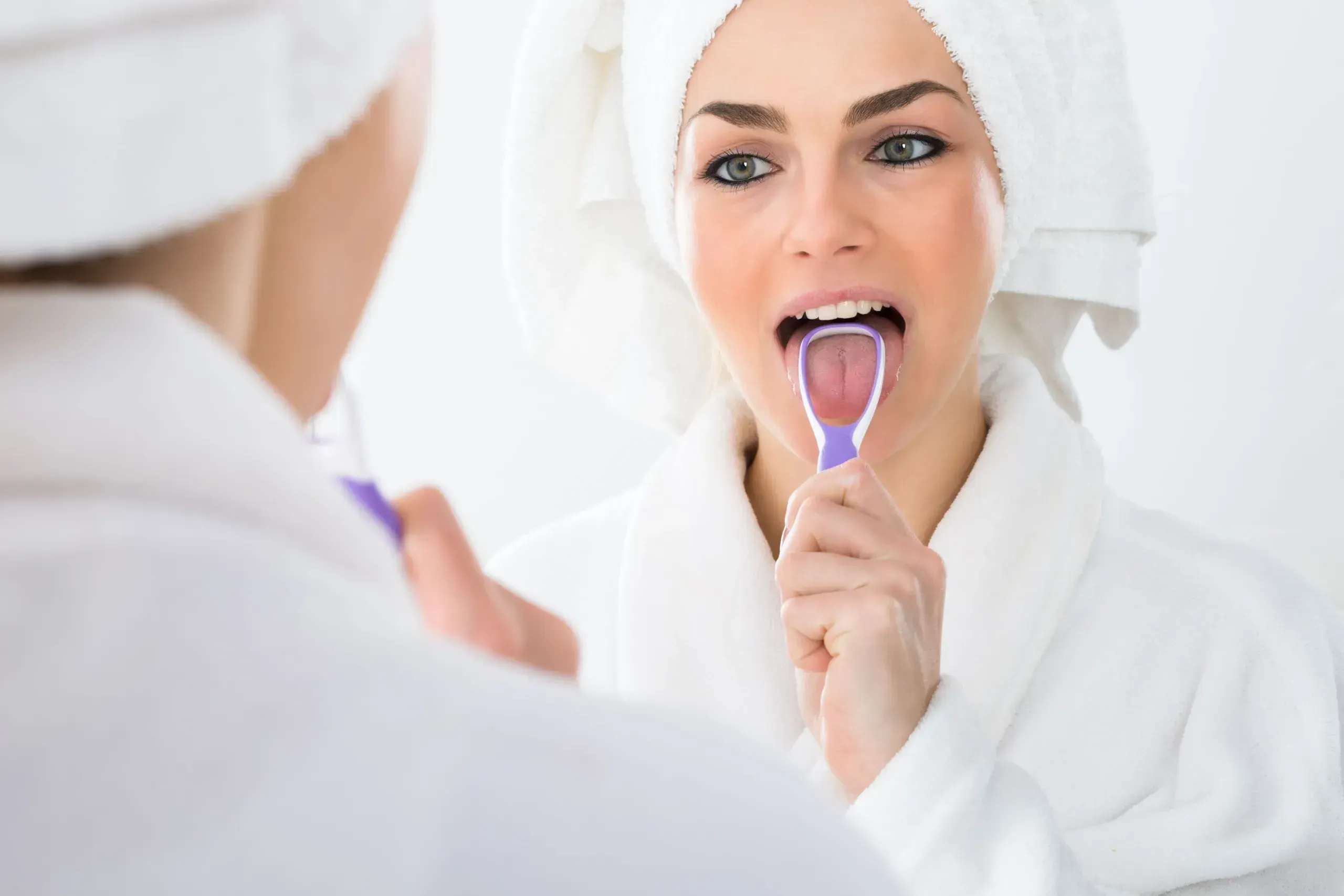 Patient checking breath in mirror at East Ellijay Family and Cosmetic Dentistry