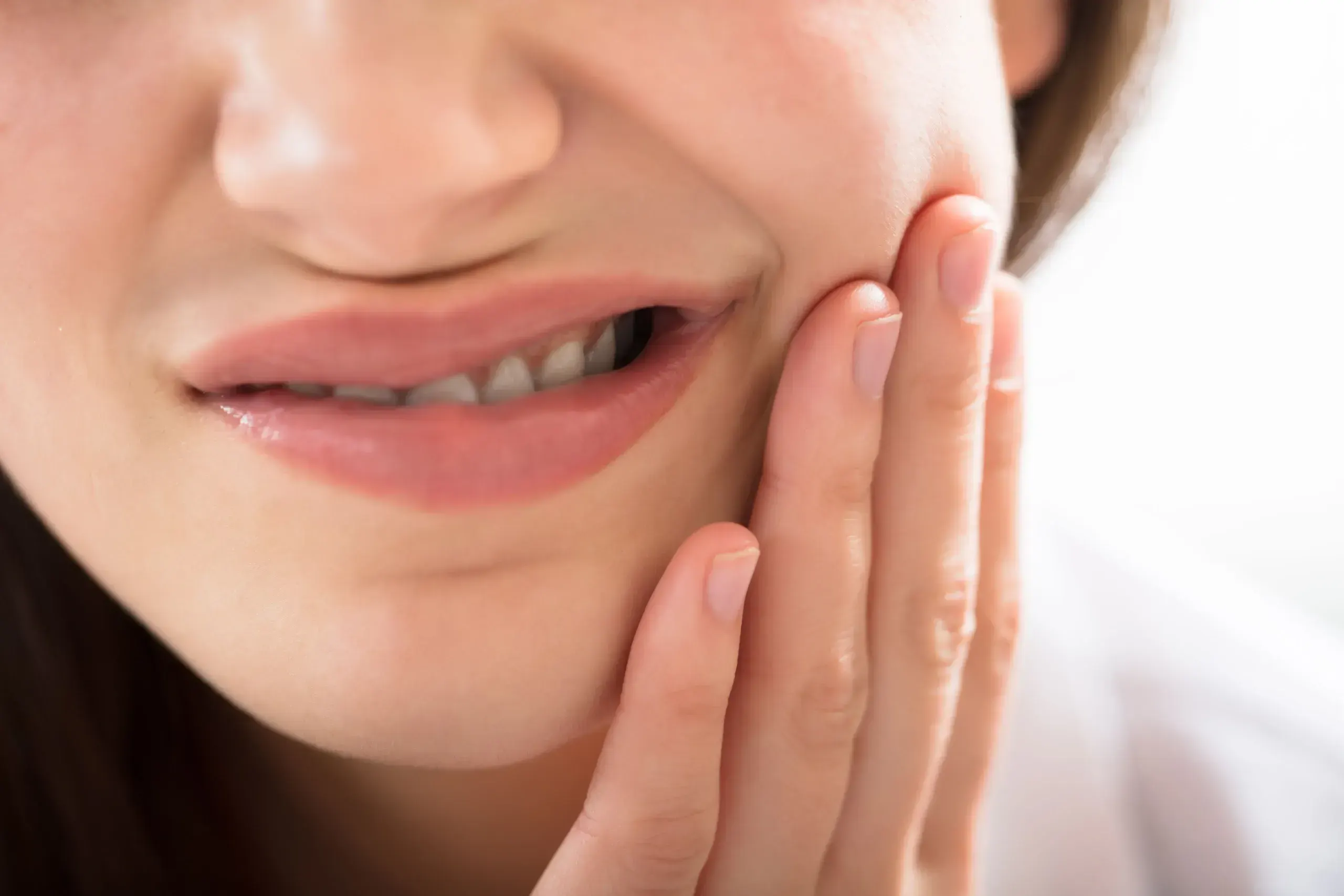 Patient pointing to a sensitive tooth during a consultation at East Ellijay Dental